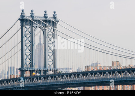 The Empire State Building seen through the steel arch of the Manhattan Bridge, New York City Stock Photo