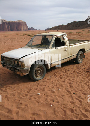 A lonely car wreck in the middle of the Wadi Rum desert, Jordan Stock Photo