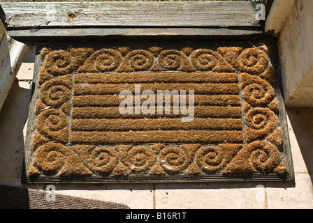 Coir door mat with scrolls and rubber backing Stock Photo