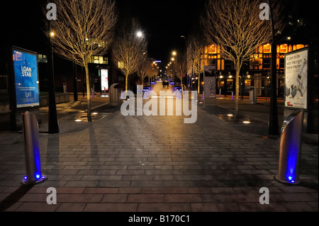 Night shot of pedestrians crossing road full of mopeds in busy