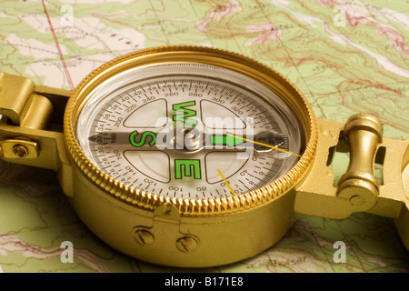 Lensatic sighting compass on a topographic map Stock Photo