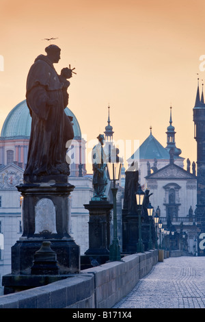 CZECH REPUBLIC PRAGUE STATUES ON CHARLES BRIDGE AT DAWN SPIRES OF THE OLD TOWN Stock Photo