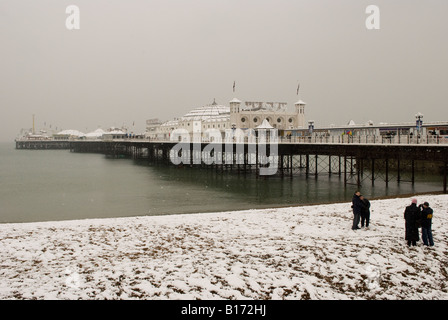 UK England Sussex, Winter:  Brighton Pier and beach in snow. Stock Photo