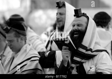 Orthodox Jewish man with tefillin and tallit, sitting alone and praying in  silence Stock Photo - Alamy