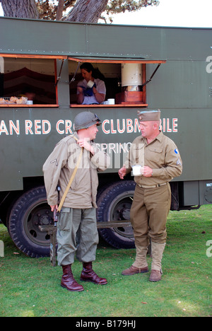 world war two american solders talking by mobile red cross canteen truck.D-day reeanactment lepe beach,hampshire,england Stock Photo