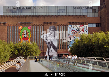 Tate Modern brick walls used for street art display of graffiti on this refurbished Bankside power station seen from Millennium London England UK Stock Photo
