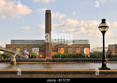 Tate Modern art gallery display street art on walls of refurbished redundant Bankside power station across River Thames in Southwark London England UK Stock Photo