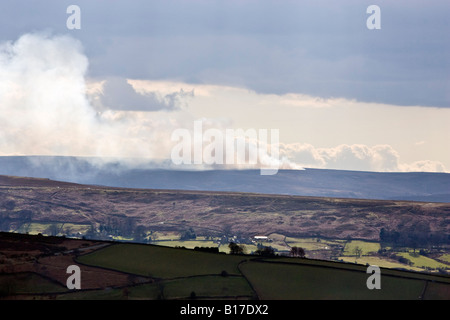 Burning heather in the North York Moors National Park near Danby. UK Stock Photo