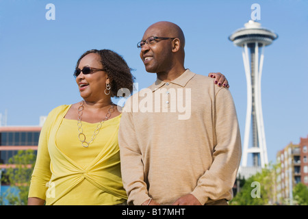 Happy african american couple hugging and smiling at camera, standing ...