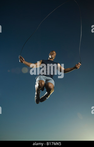 African American man jumping rope Stock Photo