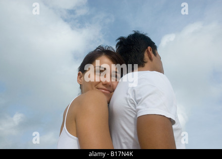 Multi-ethnic couple hugging Stock Photo