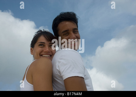 Multi-ethnic couple hugging Stock Photo