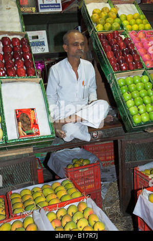 Market stall selling fresh fruit in Mumbai Bombay India with stall holder Stock Photo
