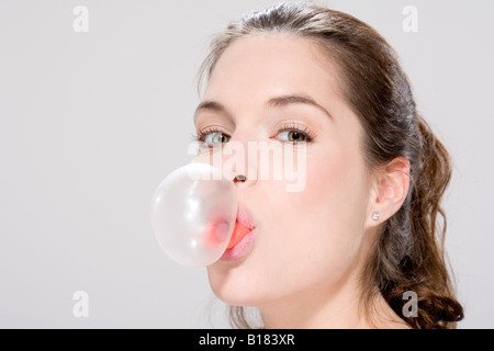 Young woman blowing bubble gum, portrait Stock Photo