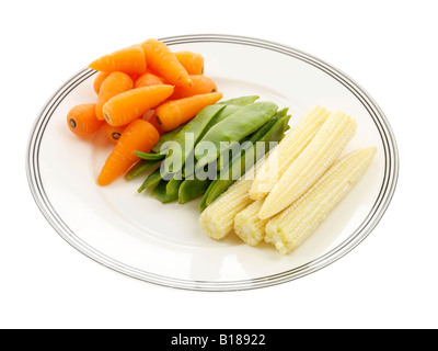 Selection Of Healthy Raw Vegetables Ready To Cook Carrots Mange Tout And Baby Corn Isolated Against A White Background With A Clipping Path Stock Photo