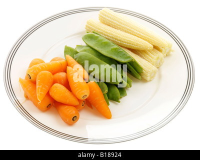 Selection Of Healthy Raw Vegetables Ready To Cook Carrots Mange Tout And Baby Corn Isolated Against A White Background With A Clipping Path Stock Photo