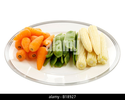 Selection Of Healthy Raw Vegetables Ready To Cook Carrots Mange Tout And Baby Corn Isolated Against A White Background With A Clipping Path Stock Photo