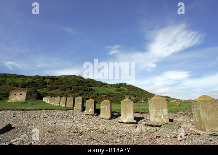 World war two tank traps and obstacles, used to defend against possible enemy attack, on the beach at Inverbervie, Scotland, UK Stock Photo