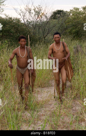The Bushmen are the oldest inhabitants of southern Africa walking in the african bush Stock Photo