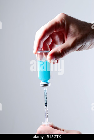 Medicine drawn from a syringe Stock Photo