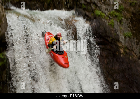 A kayaker taking a plunge into the Kuskanax Creek, Nakusp, British Columbia, Canada. Stock Photo