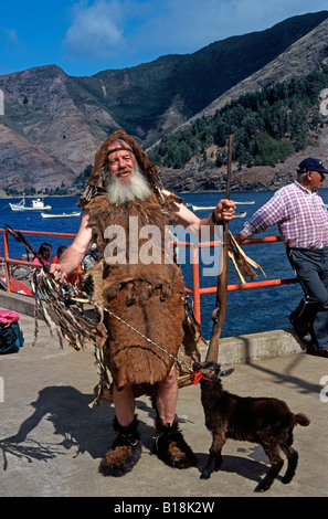 Local man on Juan Fernandes Island in Robinson crusoe dress with goat, Robinson Crusoe Island, Chile Stock Photo