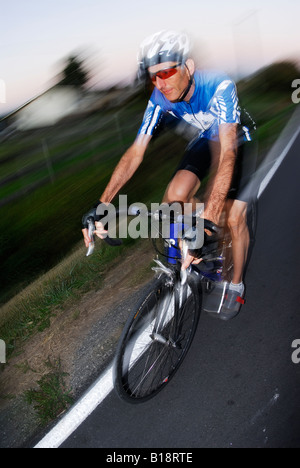 Man road cycling at Finn Slough. Richmond, British Columbia, Canada Stock Photo
