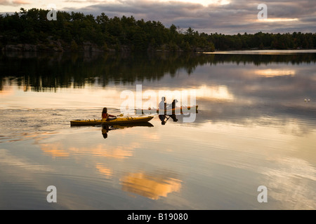 Young couple kayaking on Gull Lake near Gravenhurst, Ontario, Canada. Stock Photo