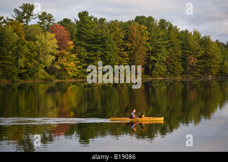 Young man kayaking with dog on Gull Lake near Gravenhurst, Ontario, Canada. Stock Photo