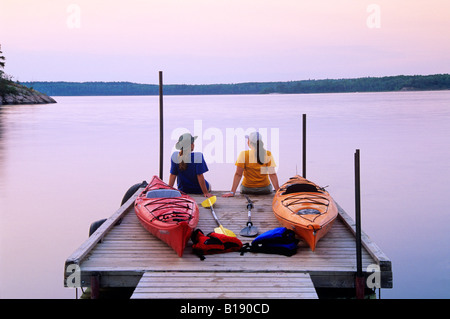 Kayakers an Nutimik Lake campground boat dock, Whiteshell Provincial Park, Manitoba, Canada. Stock Photo