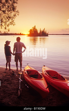 Couple with kayaks at Otter Falls campground, Whiteshell Provincial Park, Manitoba, Canada. Stock Photo