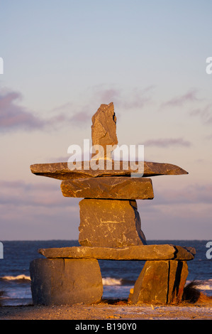 Inukshuk at sunset in the town of Churchill on the shores of Hudson Bay, Manitoba, Canada. Stock Photo