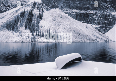 Canoe on dock at Moraine Lake after first snowfall, Banff National Park, Alberta, Canada. Stock Photo