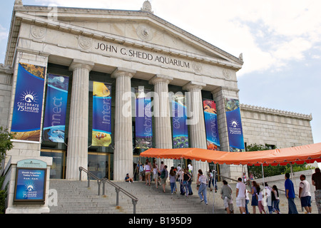 MUSEUMS Chicago Illinois People wait in line to enter Shedd Aquarium part of Museum Campus orange awning on stairs Stock Photo