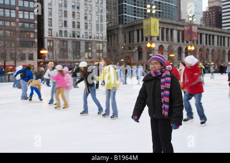 SKATING Chicago Illinois Ice skaters at Millennium Park ice rink winter fun on Michigan Avenue Stock Photo