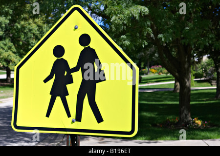 SIGNS Lincolnshire Illinois School crossing sign in residential neighborhood boy girl walking silhouette Stock Photo