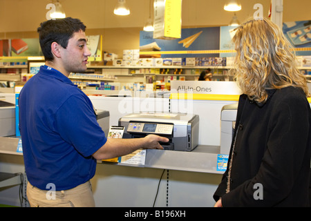 EVENTS Algonquin Illinois Salesman offer assistance to customer in OfficeMax retail store woman shopper look computer printers Stock Photo