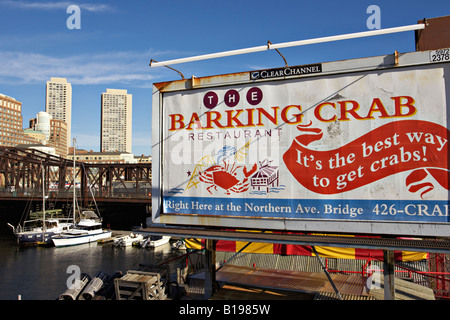 MASSACHUSETTS Boston Barking Crab restaurant in seaport district billboard at end of bridge Fort Point Channel boats and skyline Stock Photo