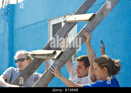 MEXICO La Paz Senior high church youth group summer missions trip painting project three teens move ladder into position Stock Photo