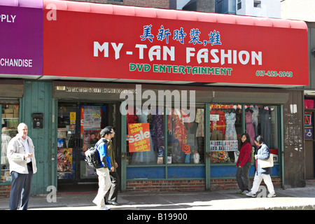 MASSACHUSETTS Boston People on sidewalk walk past restaurants and stores in Chinatown district in city Stock Photo