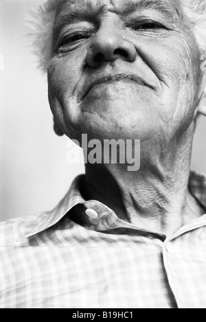 Senior man, looking at camera, low angle view, black and white, portrait Stock Photo