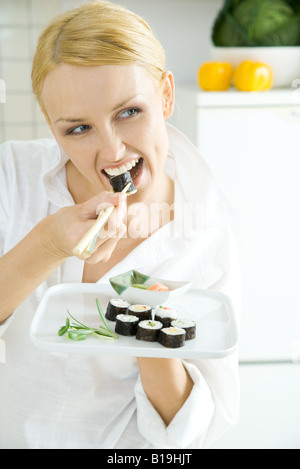 Young woman eating sushi Stock Photo