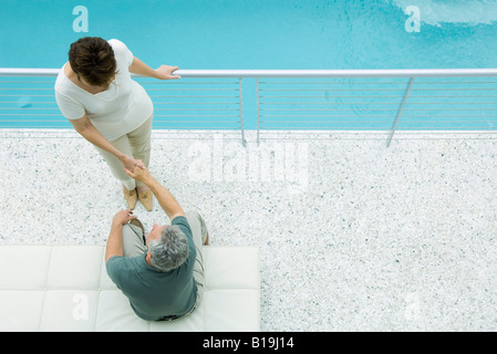 Couple on balcony, holding hands, high angle view Stock Photo