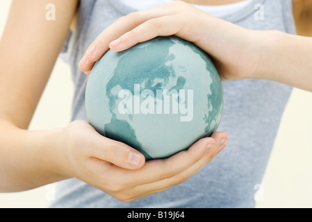 Child holding globe in hands, close-up Stock Photo