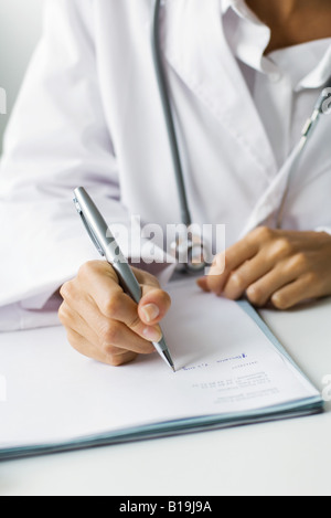 Doctor writing prescription, cropped view Stock Photo
