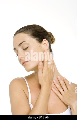 Gorgeous woman touching her neck Stock Photo - Alamy