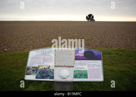information board on steel sculpture, Scallop, visible in the distance on Aldeburgh beach, Suffolk to celebrate Benjamin Britten Stock Photo
