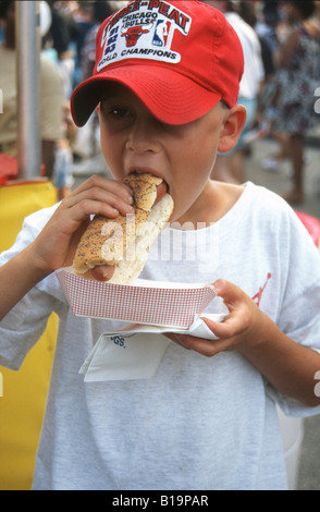 EVENTS Chicago Illinois Young boy with mouth open hold hot dog ready to eat Taste of Chicago Stock Photo