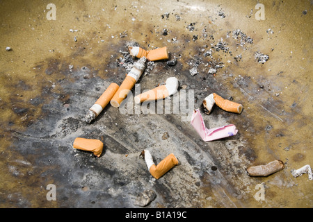 Cigarette stubs ends in rubbish bin ashtray. England, UK, Britain, Europe Stock Photo