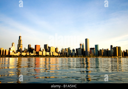 As the sun slowly rises on this spring morning, the famous skyline of Chicago, IL, begins to brighten. Stock Photo